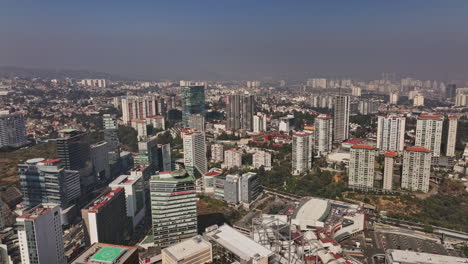 Mexico-City-Aerial-v69-panoramic-panning-shot-capturing-urban-cityscape-of-santa-fe-neighborhood-with-high-rise-buildings,-residential-towers-and-shopping-mall---Shot-with-Mavic-3-Cine---January-2022