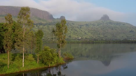 Reflections-On-Calm-Lake-Near-Trimbakeshwar-Mountain-Range-In-Western-Ghats,-Nashik,-India