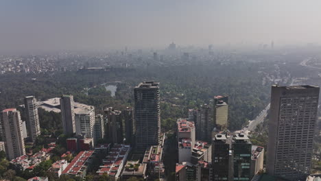 Mexico-City-Aerial-v89-panoramic-view-drone-fly-around-prestigious-polanco-neighborhood-capturing-bosque-de-chapultepec-park-and-urban-cityscape-with-foggy-sky---Shot-with-Mavic-3-Cine---January-2022