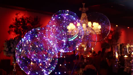 Tracking-shot-of-luminous-led-balloons-at-wedding-party