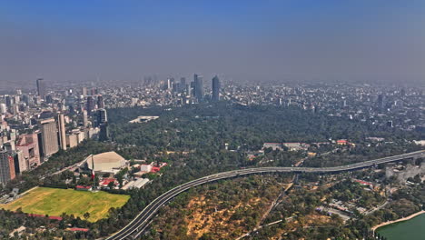 Mexico-City-Aerial-v92-establishing-shot-drone-fly-around-bosque-de-chapultepec-park-capturing-panoramic-view-of-polanco-cityscape-from-outskirt-of-central-area---Shot-with-Mavic-3-Cine---January-2022