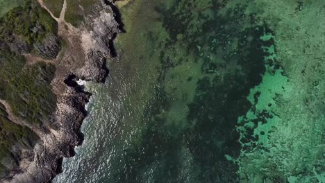 Spectacular-Kenyan-coastal-at-Watamu,-rocky-cliffs-and-seaside-landscape-of-Africa---aerial-look-down