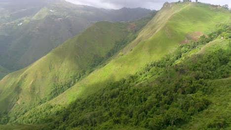 Aerial-view-green-mountains-stunning-nature-landscape,-pan-left,-environment-concept