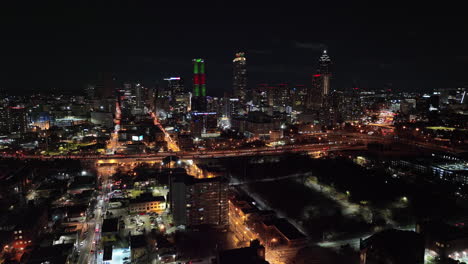 Atlanta-Aerial-v787-cinematic-reverse-flyover-sweet-auburn-and-o4w-neighborhoods-capturing-lively-downtown-cityscape-and-busy-freeway-traffic-at-night---Shot-with-Mavic-3-Cine---December-2021