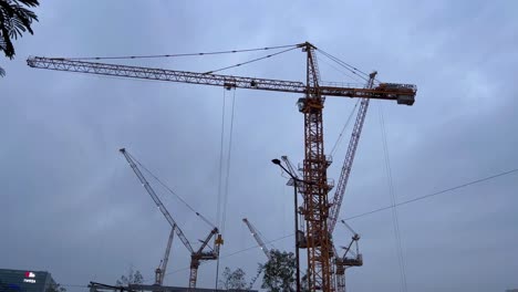 A-static-shot-of-crains-on-construction-site-of-building