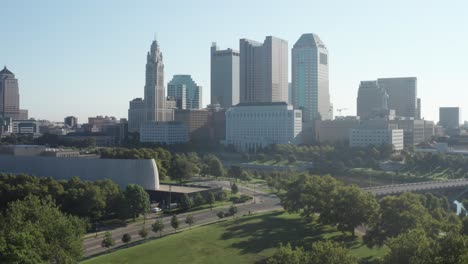 Columbus,-Ohio-skyline-on-bright-day-with-trees-moving-up