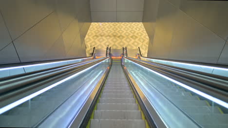 Airport-escalator-going-down,-first-person-view