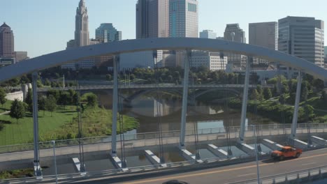 Columbus,-Ohio-close-up-of-bridge-and-drone-video-moving-up-to-skyline