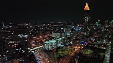 Atlanta-Aerial-v790-cinematic-shot,-drone-flyover-across-midtown-and-downtown-area-capturing-freeway-congestion-traffic-and-illuminated-night-cityscape---Shot-with-Mavic-3-Cine---December-2021