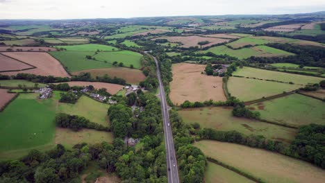 Aerial-Orbit-of-A361-Road-and-Beautiful-Fields-in-North-Devon,-England