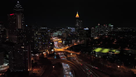 Atlanta-Aerial-v789-cinematic-low-level-flyover-capturing-illuminated-downtown-cityscape-and-traffic-congestion-on-freeway-and-complex-routes-at-rush-hours---Shot-with-Mavic-3-Cine---December-2021