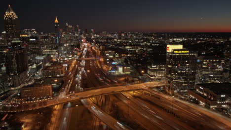 Atlanta-Aerial-v820-cinematic-broll-shot,-hyperlapse-flyover-midtown-capturing-interstate-freeway-traffic-light-trails-and-gleaming-urban-downtown-cityscape---Shot-with-Mavic-3-Cine---December-2021