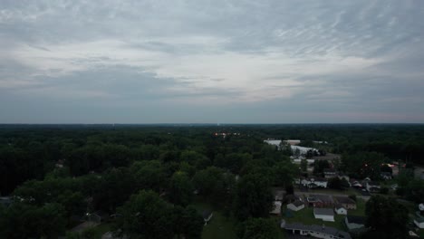 Aerial-drone-forward-moving-shot-over-small-town-at-sunset-in-Ohio,-United-States