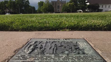 Plaque-sidewalk-static-in-front-of-the-temple-lot-in-Independence-Missouri-with-the-Church-of-Christ,-Community-of-Christ,-Remnant,-and-The-Church-of-Jesus-Christ-of-Latter-day-Saints