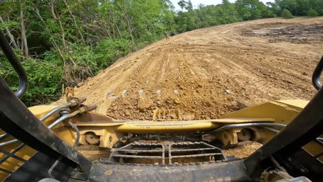 POV-while-operating-a-skid-steer-loader-to-smooth-dirt-at-a-land-development-site