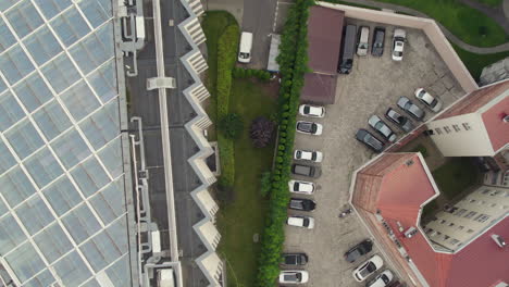 Aerial-top-view-flyover-concrete-blocks-in-Cracow-Town-with-parking-cars-during-daytime---Krakow,Poland