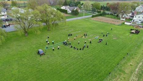 A-Drone-View-of-Amish-Farmlands-and-Homesteads-and-Approaching-Amish-Teens-Playing-Volleyball-on-a-Sunny-Day