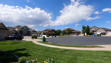 Cumulus-clouds-blowing-over-a-typical-suburban-neighborhood-on-a-sunny-day---static-wide-angle-time-lapse