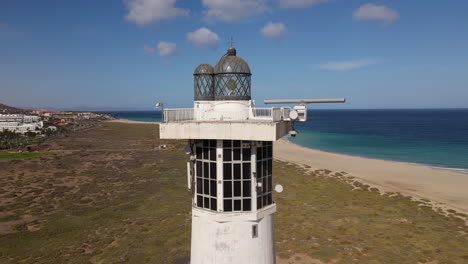Cinematic-shot-of-the-Morro-Jable-lighthouse-at-close-range-on-a-sunny-day