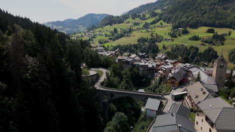 Aerial-panoramic-view-of-Steg-Hohtenn-with-many-cars-on-the-roads,-near-LÃ¶schental-Valley-in-Switzerland