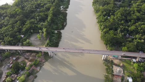 Bridge-with-traffic-over-brown-color-river-in-Bangladesh,-aerial-drone-view