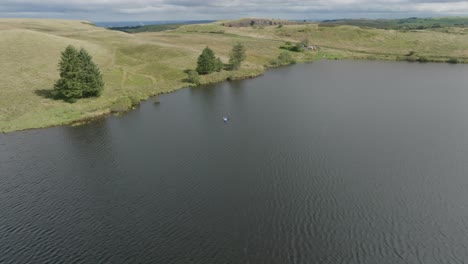 Far-Aerial-Circling-Shot-Of-A-Young-Woman-On-A-Stand-Up-Paddleboard-On-Loch-White