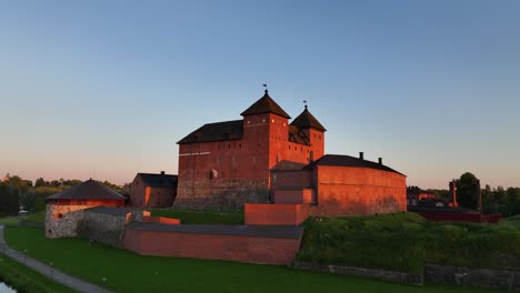 Aerial-view-towards-the-sunlit-Hame-or-Tavastia-castle,-in-Hameenlinna,-Finland---approaching,-drone-shot