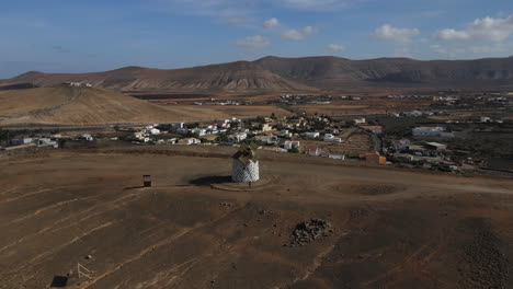Aerial-shot-away-from-a-cereal-mill-located-on-the-island-of-fuerteventura,-canary-islands,-village-of-villaverde