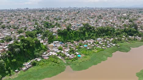 Aerial-flight-showing-poor-suburban-of-Santo-Domingo-beside-Rio-Ozama-in-Santo-Domingo