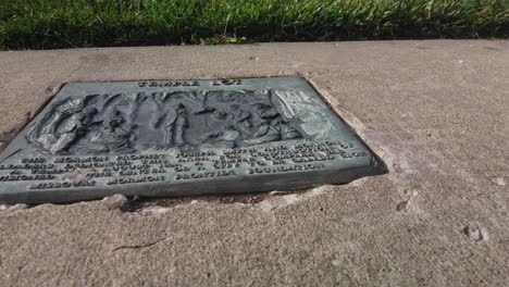 Plaque-on-the-sidewalk-in-front-of-the-temple-lot-in-Independence-Missouri-with-the-Church-of-Christ,-Community-of-Christ,-Remnant-and-The-Church-of-Jesus-Christ-of-Latter-day-Saints