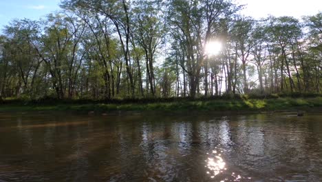 The-setting-sun-through-trees-along-the-Saco-River-in-Maine