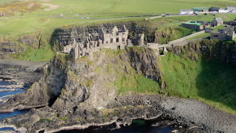 A-zoomed-out-aerial-shot-of-Dunluce-Castle-in-Ireland,-the-setting-for-the-Game-of-Thrones-series