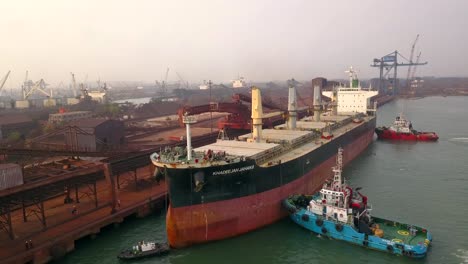 A-Large-Bulk-Carrier-In-Paradip-Port-At-Sunrise-In-Odisha,-India---drone-shot