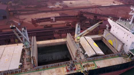 Bulk-Carrier-With-Cargo-Holds-Open-For-Loading-At-Paradip-Port,-Odisha,-India---drone-shot