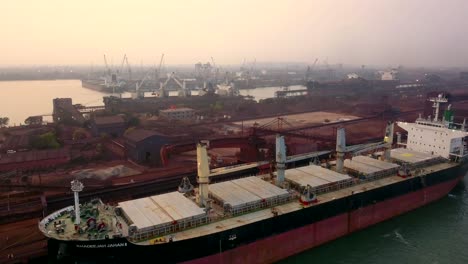 Bulk-Carrier-Docked-At-Paradip-Port-Waiting-To-Unload-Cargo-In-Odisha,-India---aerial-shot