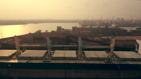 Big-Cargo-Ship-Bulk-Carrier-At-Paradip-Port-During-Sunset-In-Odisha,-India---aerial-drone-shot