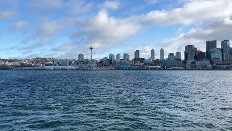 A-view-of-the-Seattle,-Washington-city-skyline-at-daytime-as-seen-from-a-ferry-crossing-Elliott-Bay