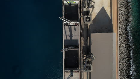 Aerial-shot-from-above-of-one-of-the-ships-that-transport-cement-from-the-Arquineguin-factory-on-the-island-of-Gran-Canaria,-Spain