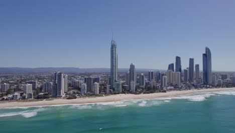 Q1-Tower-And-Skyscrapers-On-The-Beach-In-Surfers-Paradise,-Queensland,-Australia---aerial-shot