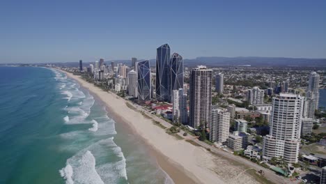Long-Stretch-Of-White-Sand-Beach-With-Jewel-Gold-Coast-Towers-In-Surfers-Paradise,-QLD,-Australia---aerial-drone-shot