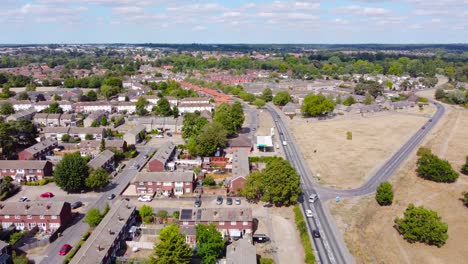 Aerial-footage-over-a-busy-road-revealing-empty-lands-to-develop-and-the-housing-estates-in-Norfolk,-England