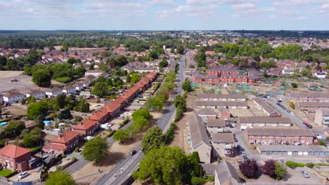 Aerial-footage-sliding-towards-the-right-while-following-the-movement-of-vehicles-also-revealing-Norfolk-housing-estates-in-England-and-a-fantastic-view-in-the-horizon