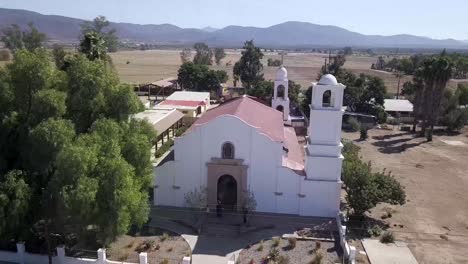 Drone-flying-around-a-church-entrance-during-a-wedding