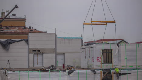 Time-lapse-shot-of-worker-on-construction-site-build-container-house-until-night