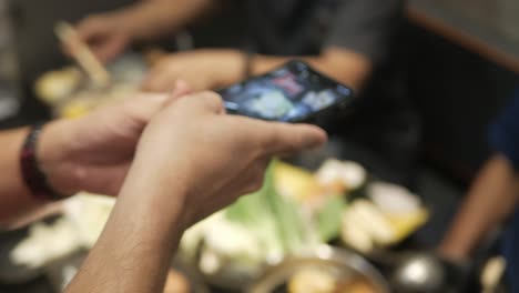 Using-smart-mobile-phone-to-take-a-vertical-video-of-hotpot-shabu-shabu-in-japanese-style-for-social-media-sharing