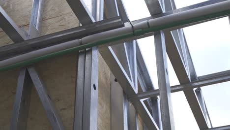 Close-up-of-steel-framing-at-house-construction-site,-up-shot