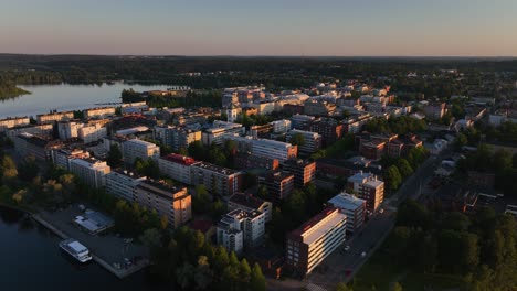 Aerial-view-around-the-cityscape-of-sunlit-Hameenlinna,-Finland---circling,-drone-shot