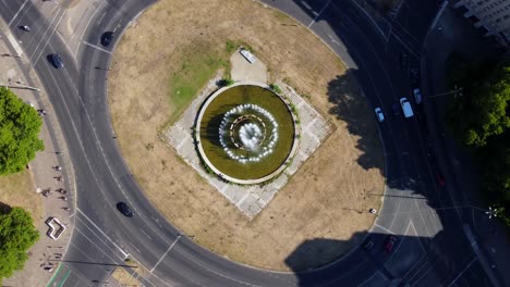 Aerial-top-down-bird's-eye-view-drone-vertical-9:16-view-of-roundabout-traffic-Berlin-Strausberger-Place-Fountain-Germany-at-summer-afternoon-August-2022