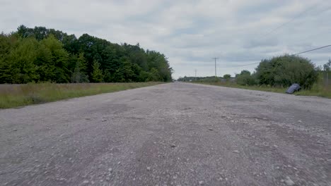 Close-to-ground-Point-of-View-shot-on-a-gravel-road