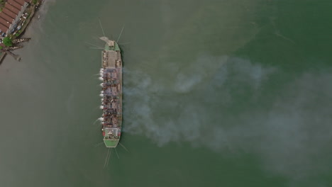 Static-top-down-aerial-footage-of-a-ship-in-the-bay-outside-of-Freetown,-Sierra-Leone-with-four-smokestacks
